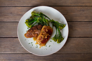 Duck breast fillets with caramelized onion and broccoli. View from above, top studio shot