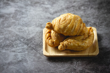 Curry puff pastry on concrete background.