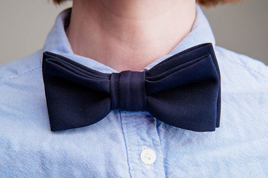 Dark Blue Bow Tie On A Woman's Neck