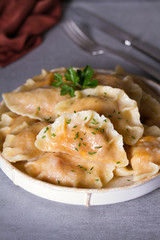 Dumplings, filled with cabbage. Varenyky, vareniki, pierogi, pyrohy - dumplings with filling