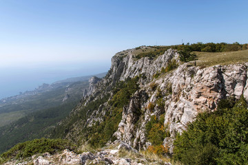 Scenic view of Mount Ai-Petri over the Black Sea in haze in autumn, Crimea, Russia. One of the highest mountains of the Crimean peninsula. A favorite place for tourists.  Selective focus