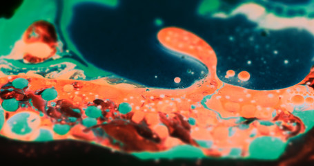 Macro Paint with Neon Color Palette. Oil Mixed with Orange and Green Dye and Paint. Green Bubbles.