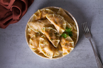Dumplings, filled with cabbage. Varenyky, vareniki, pierogi, pyrohy - dumplings with filling. View from above, top studio shot