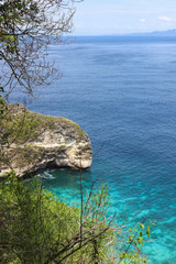 Top View of Suwehan beach on Nusa Penida Island, Bali, Indonesia. Amazing  view, green plants, white sand beach with rocky mountains and azure lagoon with clear water of Indian Ocean 