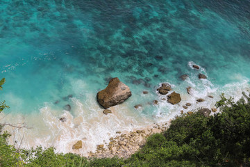 Top View of Suwehan beach on Nusa Penida Island, Bali, Indonesia. Amazing  view, green plants, white sand beach with rocky mountains and azure lagoon with clear water of Indian Ocean 