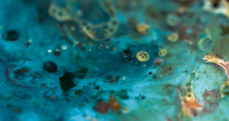 Macro Paint with Vibrant Color Palette. Oil Mixed with Bright Teal and Yellow Dye and Paint.