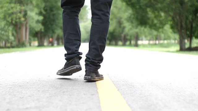 Asian man walking exercise on a beautiful road