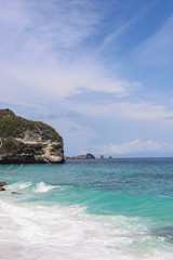 Suwehan beach on Nusa Penida Island, Bali, Indonesia. Amazing  view, white sand beach with rocky mountains and azure lagoon with clear water of Indian Ocean 