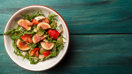 Diet menu. Healthy salad of fresh figs, strawberries, grapes, blue cheese dorblu. Long banner format, top view