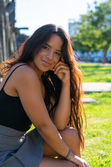 young woman sitting or standing next to a wooden and iron bridge