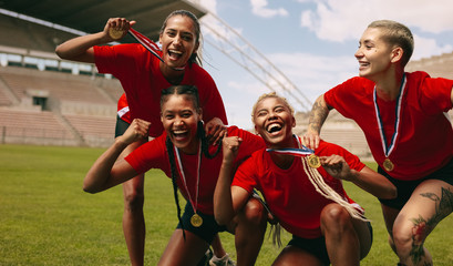 Female soccer team cheering together after the game league - Powered by Adobe