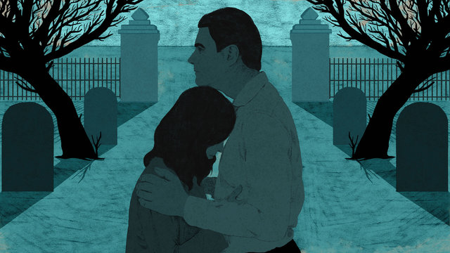 Grieving couple in cemetery