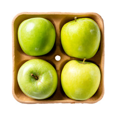 Green apples on pulp paper food tray isolated on white. Top view.