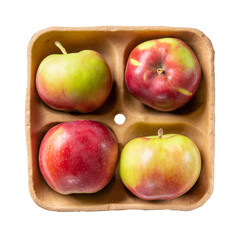 Red apples on pulp paper food tray isolated on white. Top view.