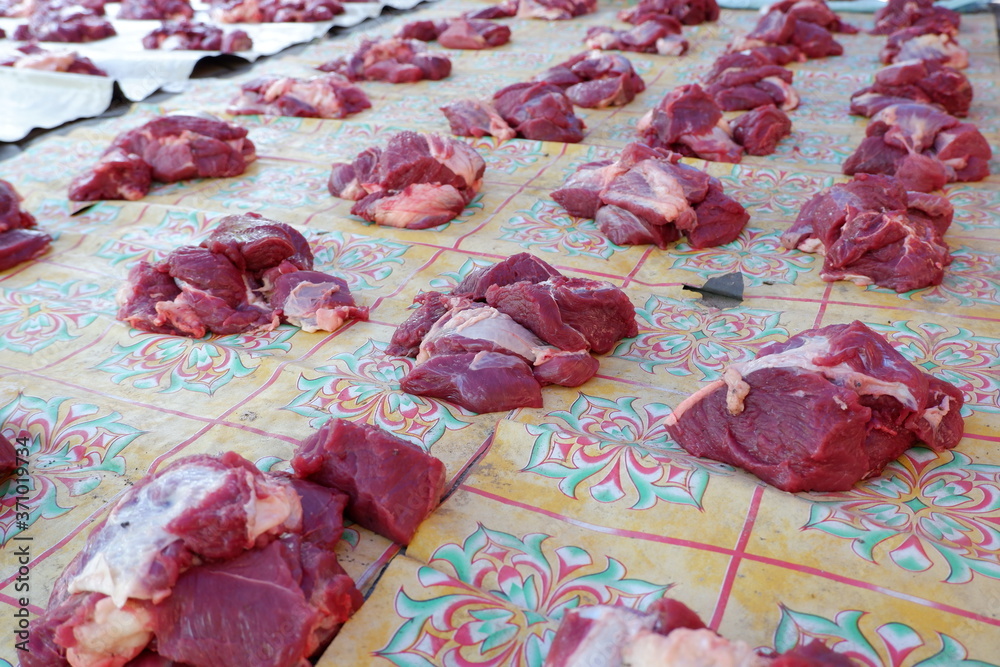 Wall mural Fresh red beef is cut into small pieces to celebrate the Muslim holiday, Eid al-Adha