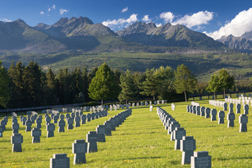 Fototapeta na wymiar German military cemetery in autumn with mountains in the background and many graves of soldiers killed in the Second World War. Sunny day, Slovakia, Europe.