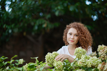 Portrait of a happy young woman outside in a garden