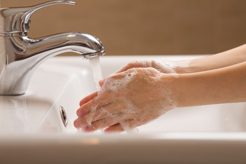 Child washing his hands with soap, hygiene and cleaning concept.