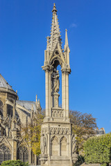 Fototapeta na wymiar Fountain of Virgin (1845) in Square Jean XXIII near east side of Cathedral Notre Dame de Paris. - Eastern half of the Cite Island, Paris, France.