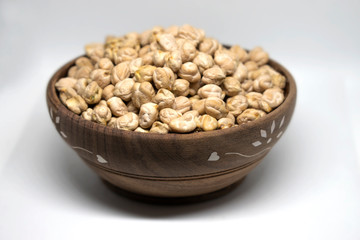 White Chick Pea or Kabuli Chana isolated in wooden bowl on White Background