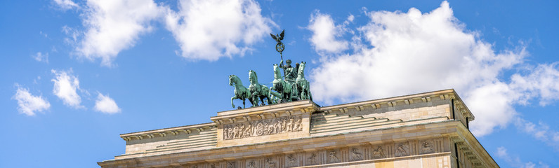Fototapeta na wymiar Brandenburg Gate with Quadriga statue as panorama background in summer, Berlin, Germany
