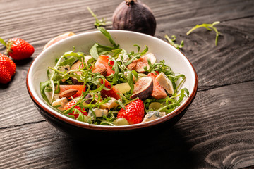 Healthy food. salad with figs, strawberries, grapes, blue cheese dorblu