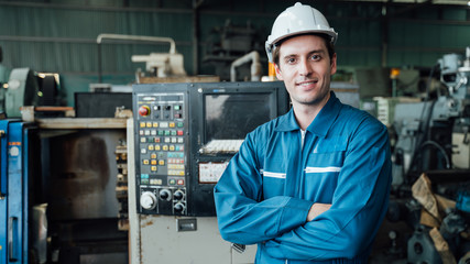 Engineer,Industry and construction concept. Portrait of caucasian Industry factory maintenance engineer wearing uniform and safety helmet in factory.