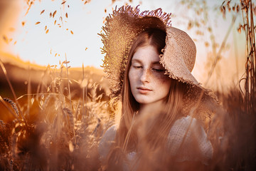 Young, teen, ginger girl with freckles wearing a summer hat. In the wheat field. , outdoor scene,...