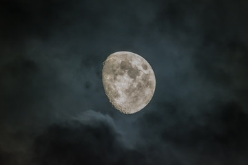 Naklejka na ściany i meble Waxing Gibbous phase moon with dark clouds