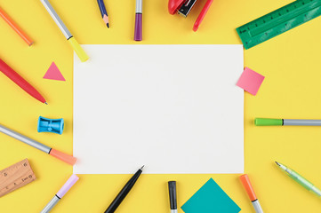 white sheet of paper and school office on yellow background