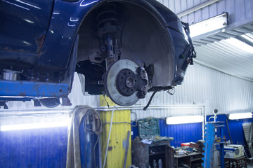 Car suspension repair. Replacement of brake discs and pads.