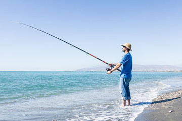 Man angling on the beach