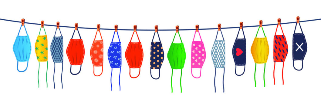 The colorful reusable masks are hanging on a line.
Drying reusable masks.