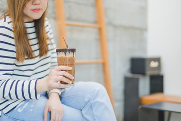 asian woman drink ice latte coffee in modern coffee shop