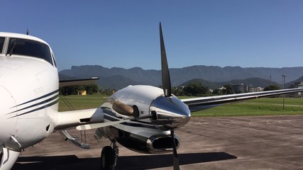 Private turboprop executive aircraft parked on airstrip
