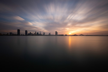 Fototapeta premium Bahrain skyline with dramatic clouds during sunset