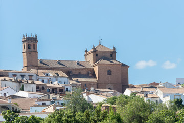 Fototapeta na wymiar Facade and bell tower of church San Mateo, gothic and renaissance church, in old town of Banos de la Encina, Jaen, Andalusia, Spain