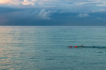 Two Swimmers in the Irish Sea at Dusk