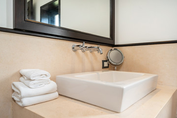 Interior design of house, home, villa, condo and apartment feature sink with towels, mirror and tap