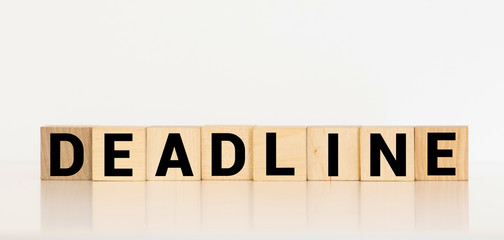 DEADLINE word written on wood block. DEADLINE text on wooden table for your desing, concept.