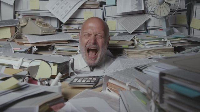 Stressed businessman overloaded with paperwork