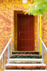 Staircase leading to a red door