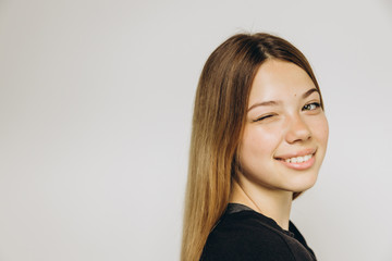 A teenage girl against grey background with copy space