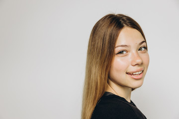 A teenage girl against grey background with copy space