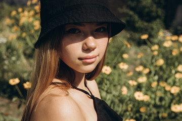 A teenage girl is having a walk in a green city park