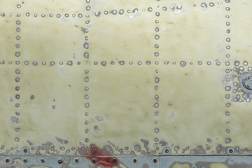 background of the fuselage of the aircraft. Yellow-green metal surface asscelled