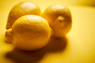 fresh lemons on a yellow minimalistic background