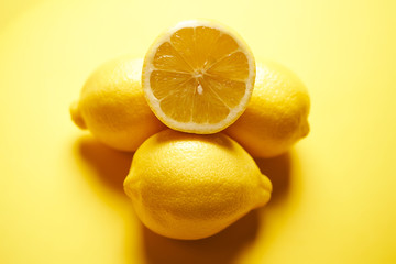fresh lemons on a yellow minimalistic background