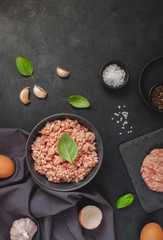 Raw minced meat in bowl on wooden table