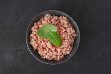 Raw minced meat in bowl on wooden table